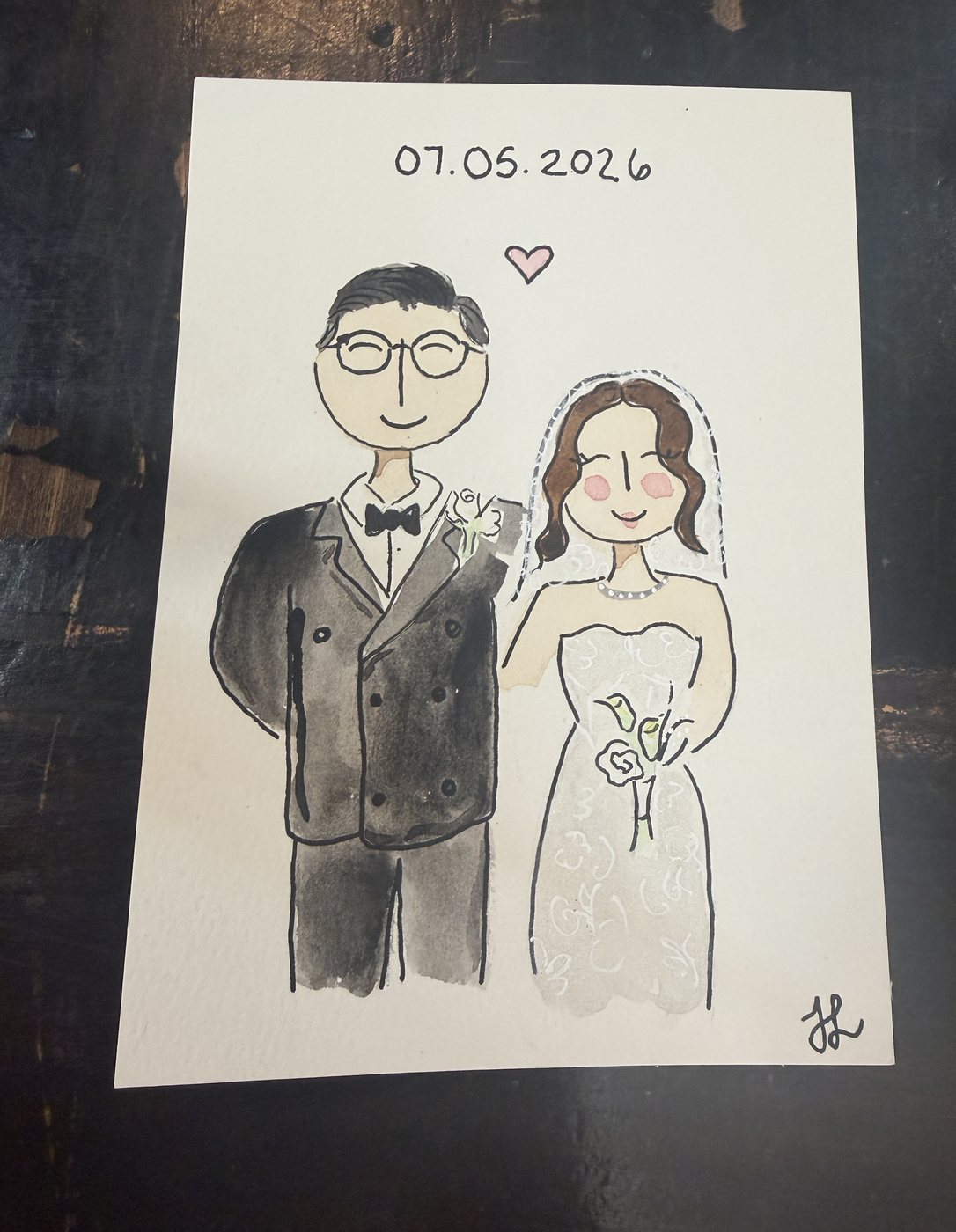 Live guest portrait of a bride and groom, dated 07.05.2026, with a small heart painted between them