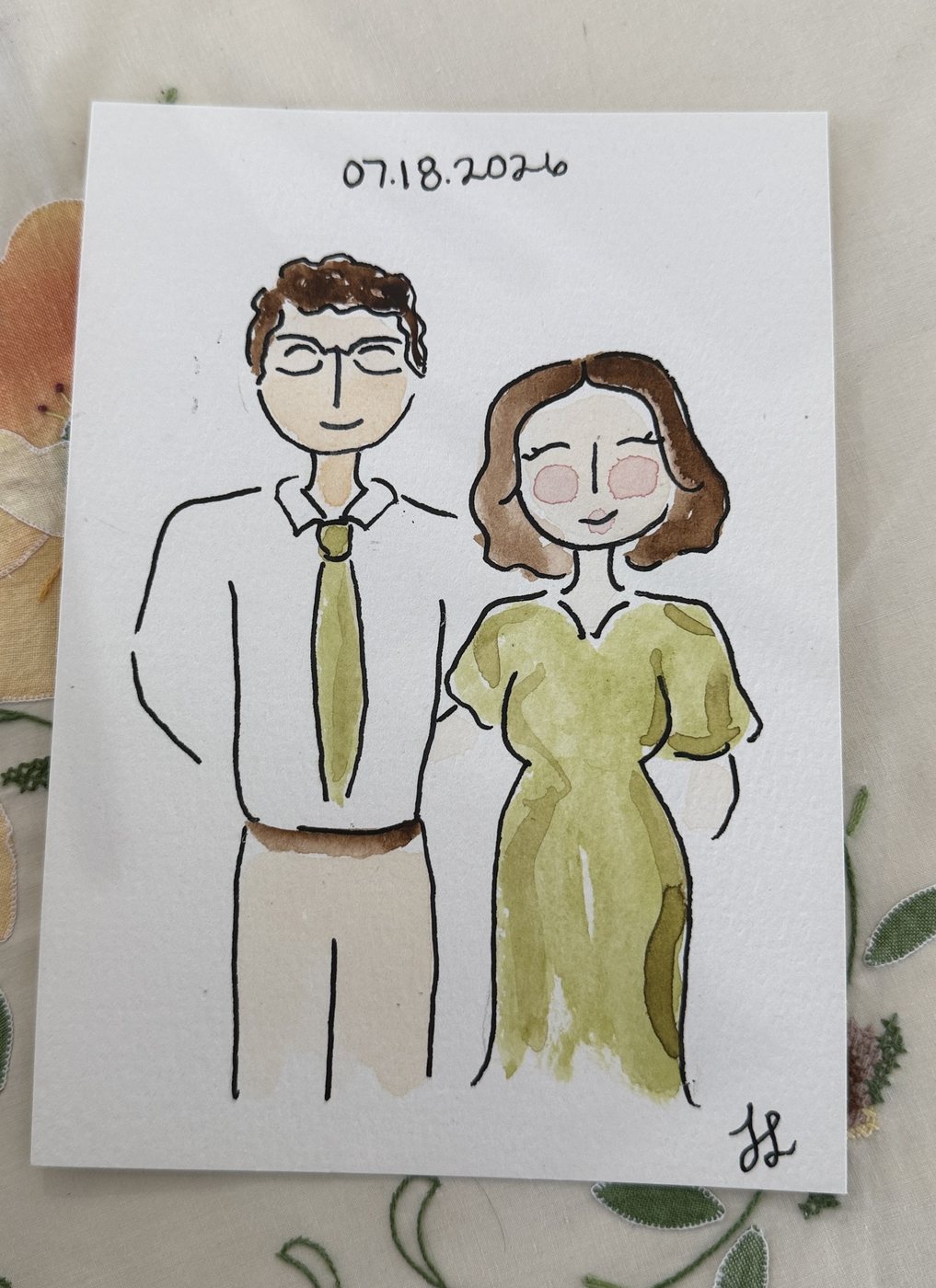 Live guest portrait of a couple, the man in a white shirt and green tie and the woman in a green dress, dated 07.18.2026